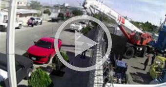 Crane narrowly misses hitting man and brand new ca