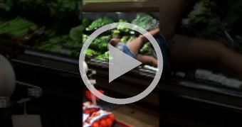 Woman Bathes in Produce at Supermarket